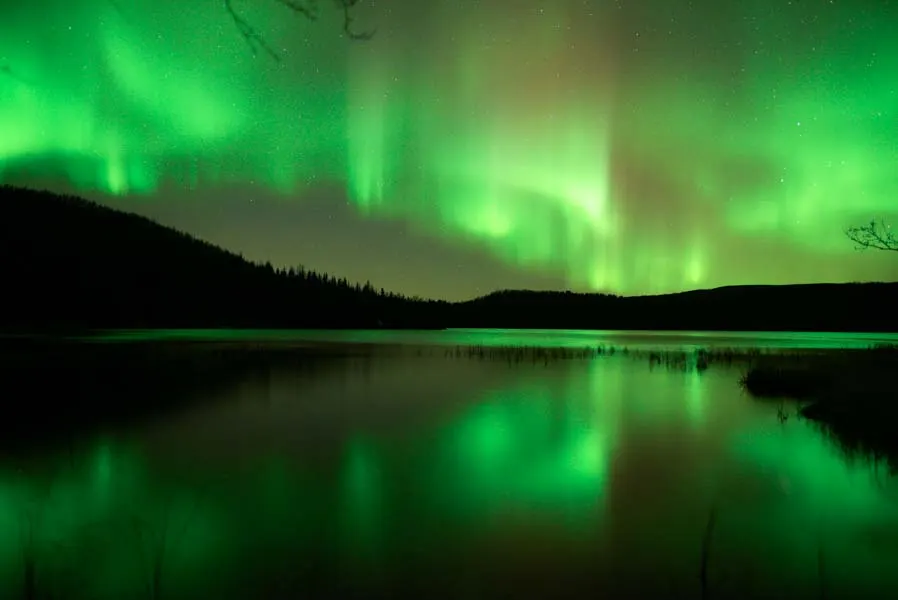Aurora mirrored in a dark lake