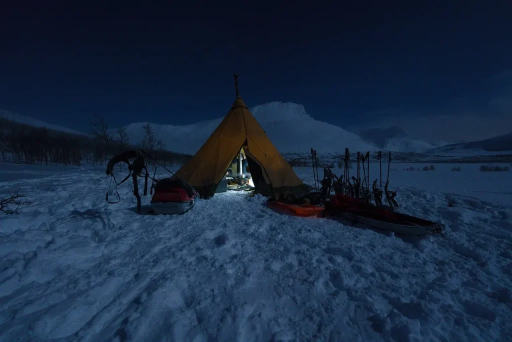 A lit tipi tent at blue hour