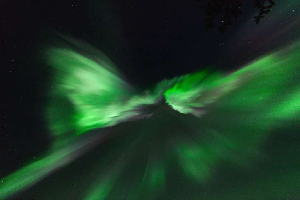 The aurora bursting straight overhead