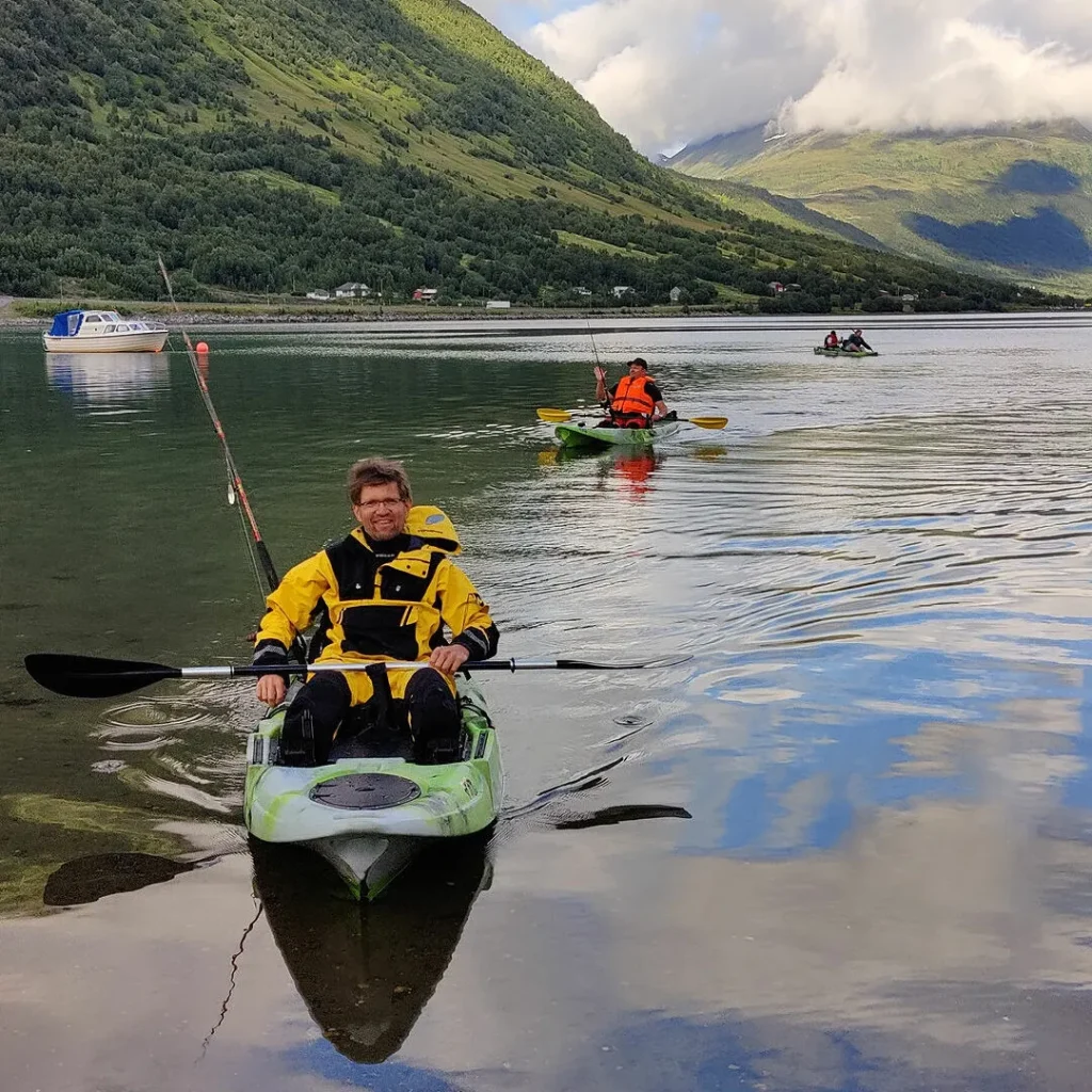 Paddling a kayak on a calm summer fjord