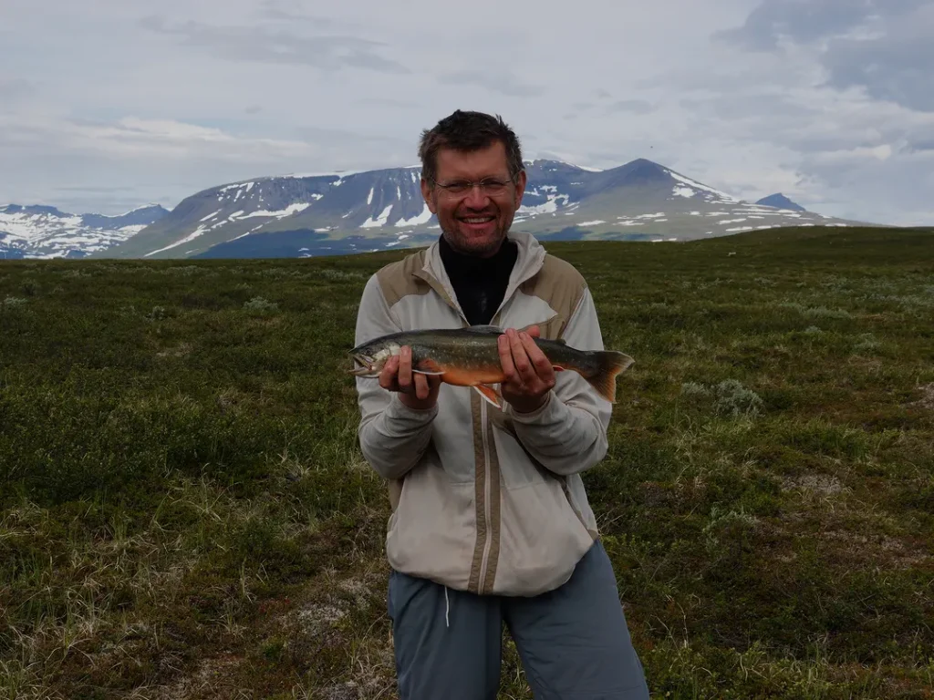 Roy with a trout on the summer tundra